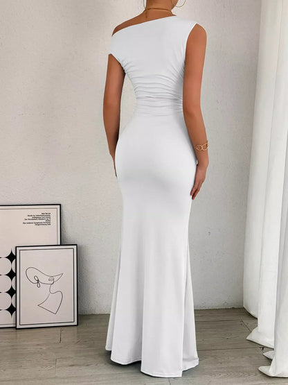 Navy ruched maxi dress with off-shoulder neckline, fitted waist, and flowing skirt