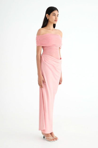 Side profile of pink ruched maxi dress with off-shoulder fit