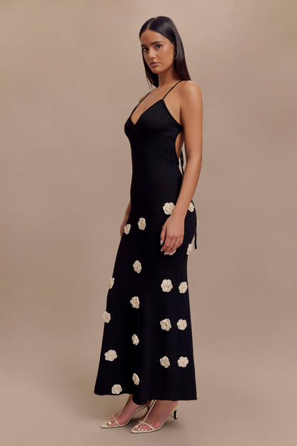 Black camisole maxi dress with scattered cream floral details, side view