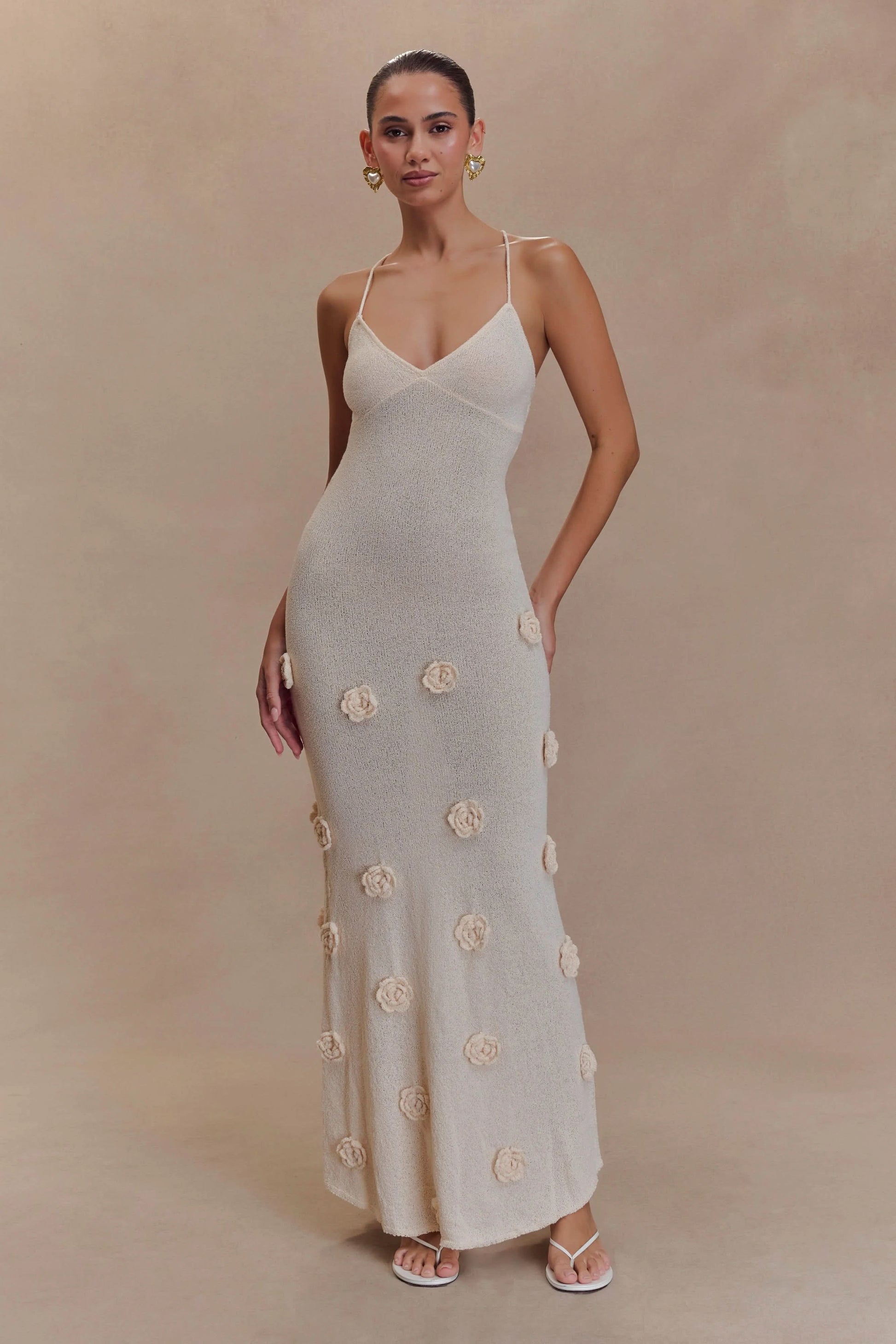 Cream maxi dress with textured rose appliqués and thin straps