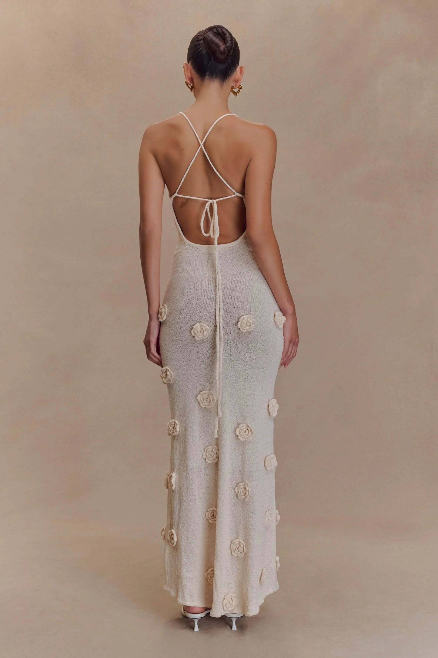 Cream maxi dress back view with tied straps and scattered floral embellishments
