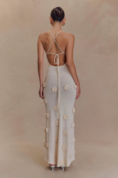 Cream maxi dress back view with tied straps and scattered floral embellishments