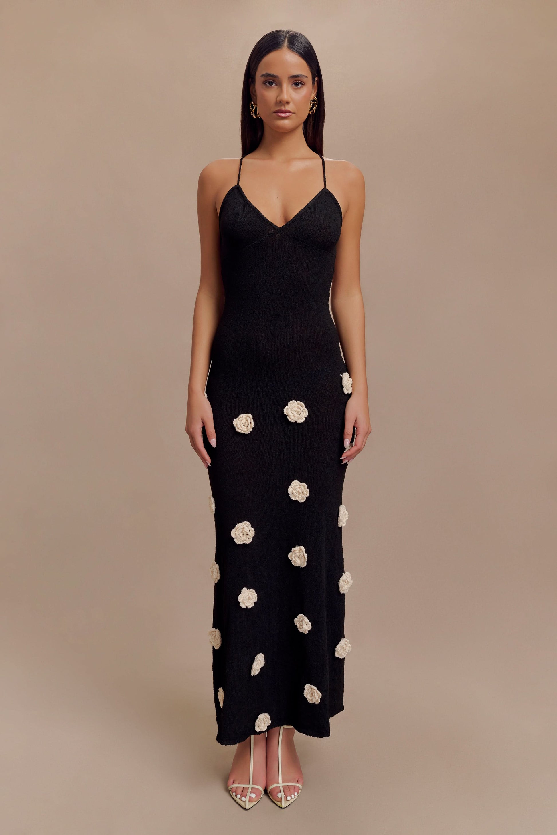 Black maxi dress with cream floral appliqués and thin crisscross straps
