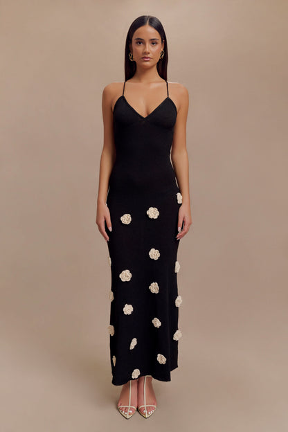 Black maxi dress with cream floral appliqués and thin crisscross straps