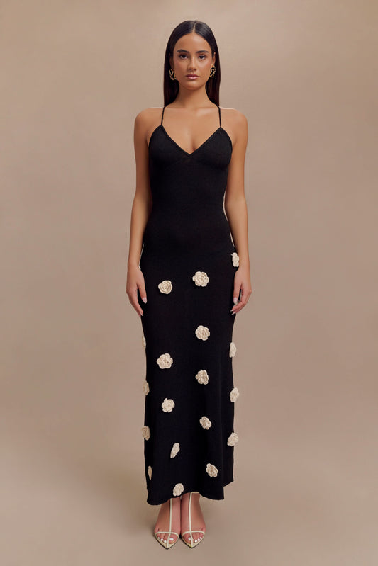 Black maxi dress with cream floral appliqués and thin crisscross straps