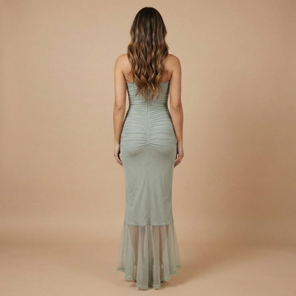 Back view of sage green ruched maxi dress showing sweetheart back and flowing ruffled hemline
