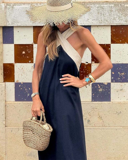 Navy sleeveless maxi dress with cream crossed halter straps detail
