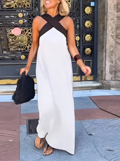 White maxi dress with black crossover straps and floor-length hem