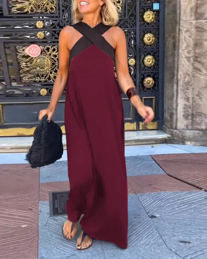 Burgundy maxi dress with black crossover straps and draped hem