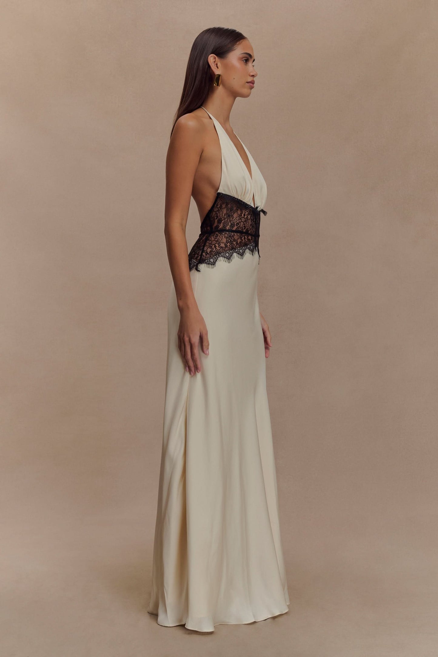 Cream halter maxi dress with black lace waist detail and V-neckline