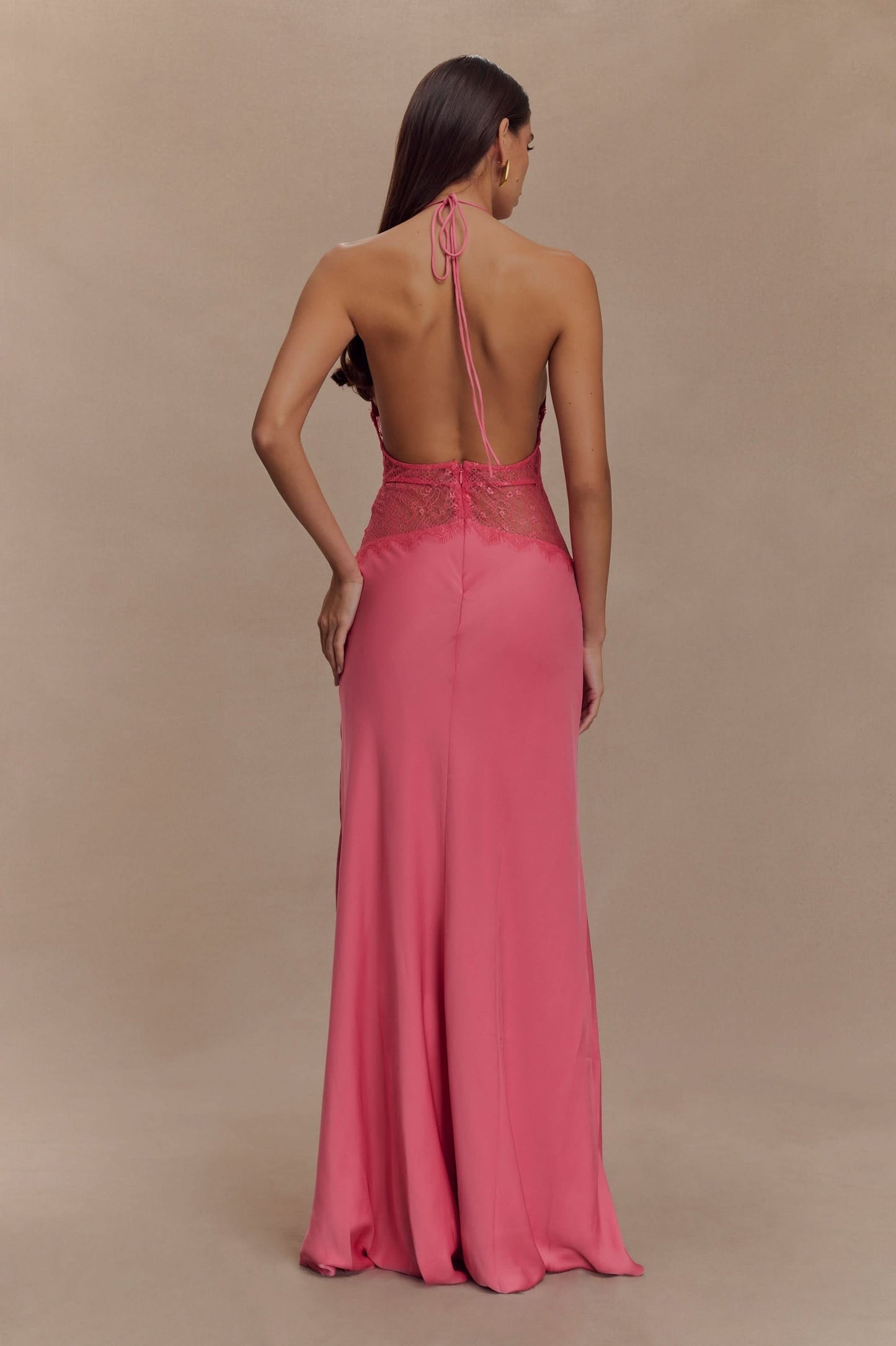 Back view of pink lace maxi dress with halter tie and flowing train