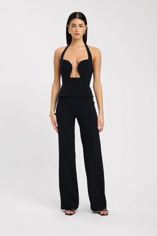 Black halter bustier top with plunge cutout and molded cups styled with high-waisted pants for women