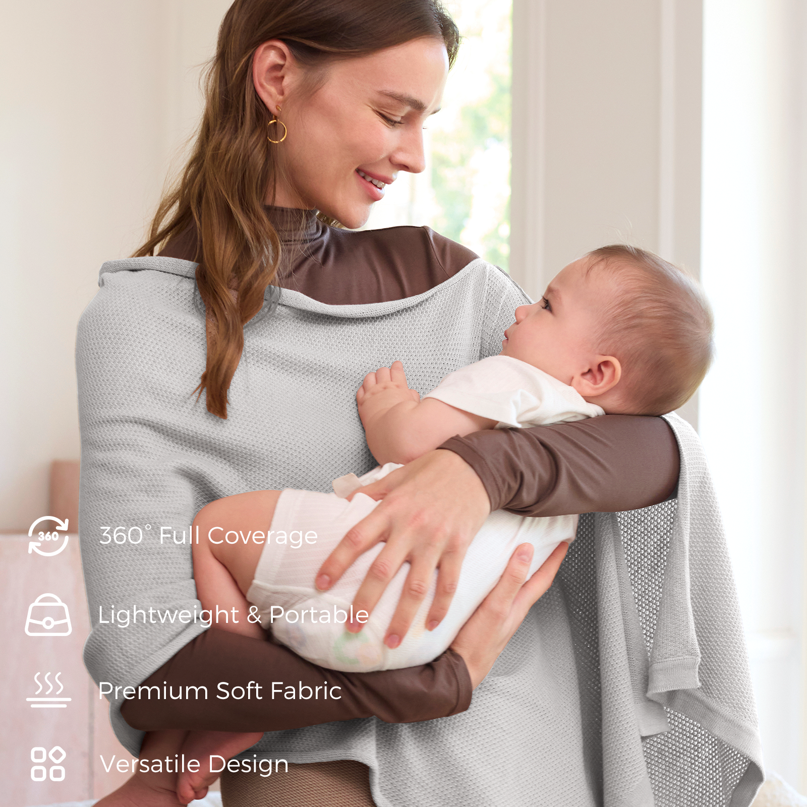 Mother holding infant while wearing taupe nursing poncho with lightweight design