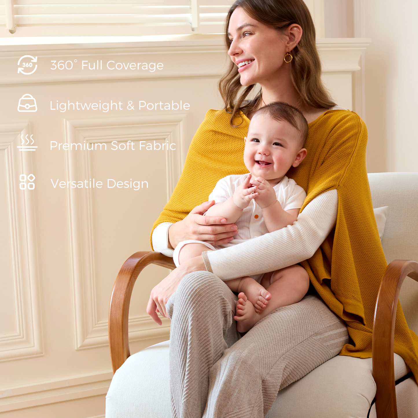 Mother in mustard nursing poncho holding smiling baby in chair