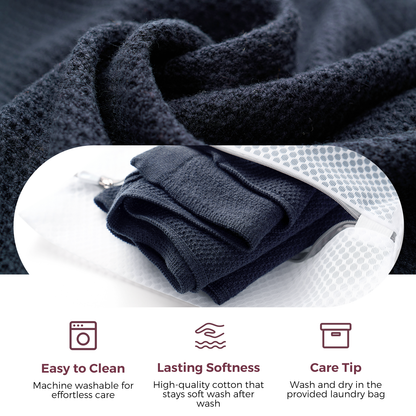 Folded dark navy nursing poncho showing breathable mesh knit texture