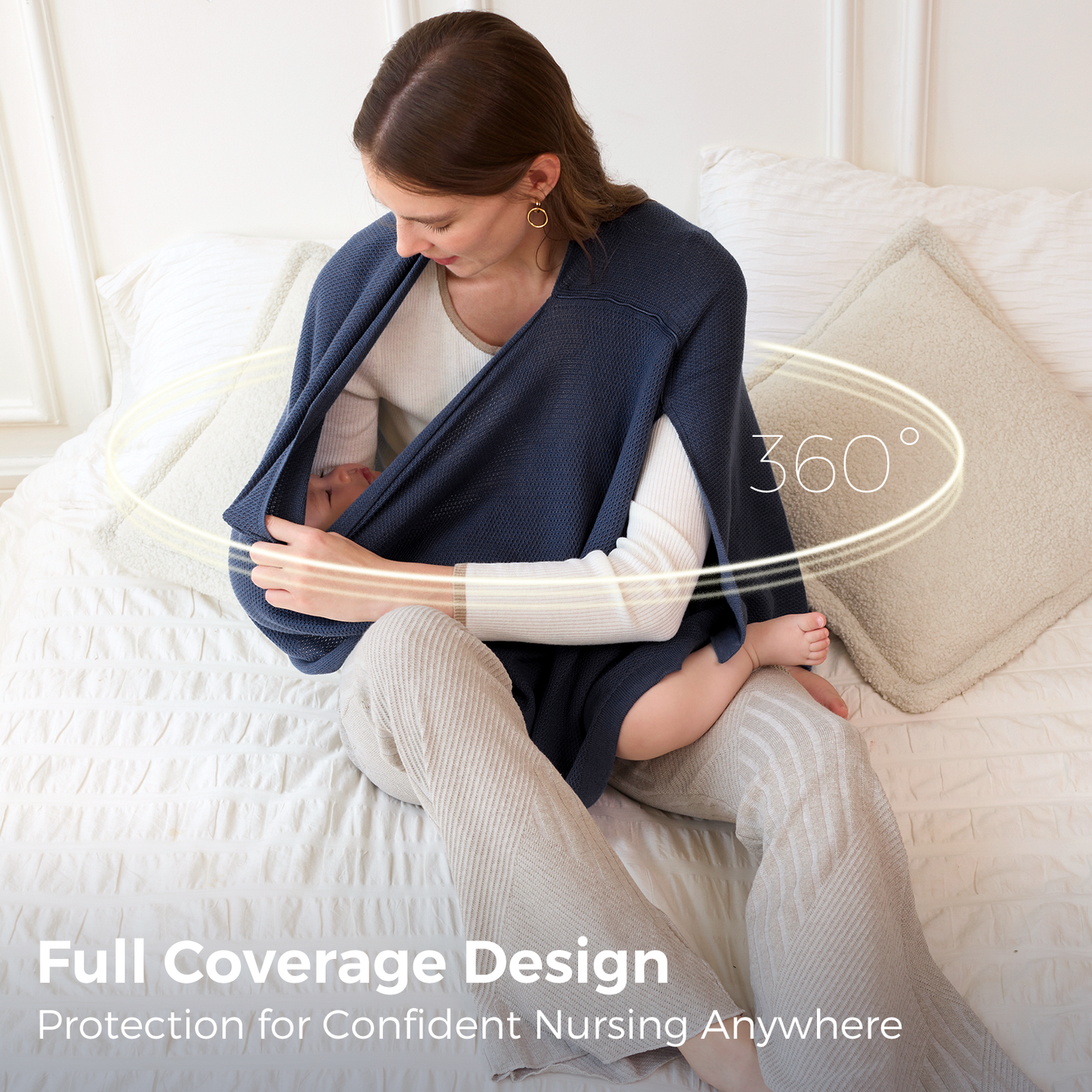 Woman nursing baby under navy poncho with 360-degree coverage