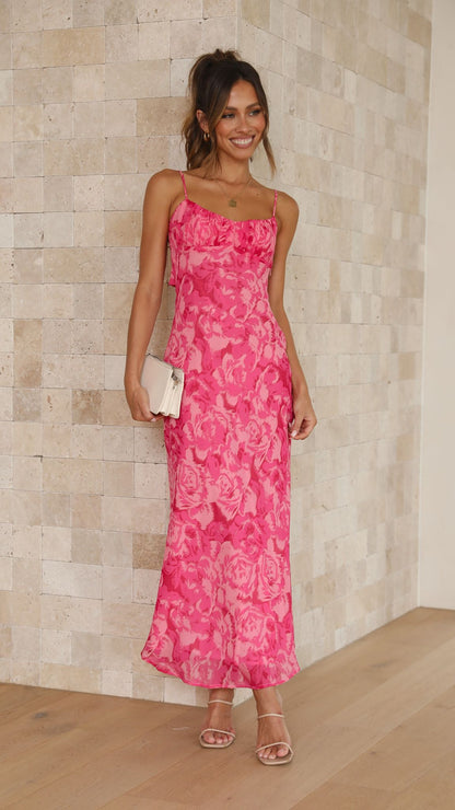 Front angled view of pink floral midi dress with spaghetti strap detail