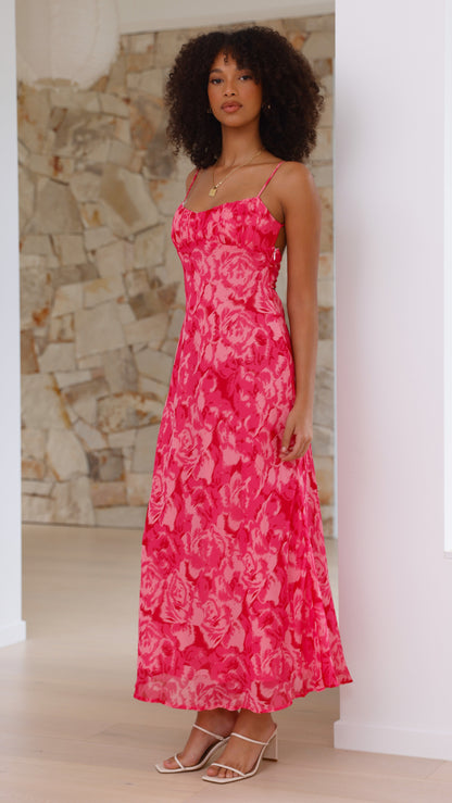 Side view of pink rose print midi dress with flowing skirt