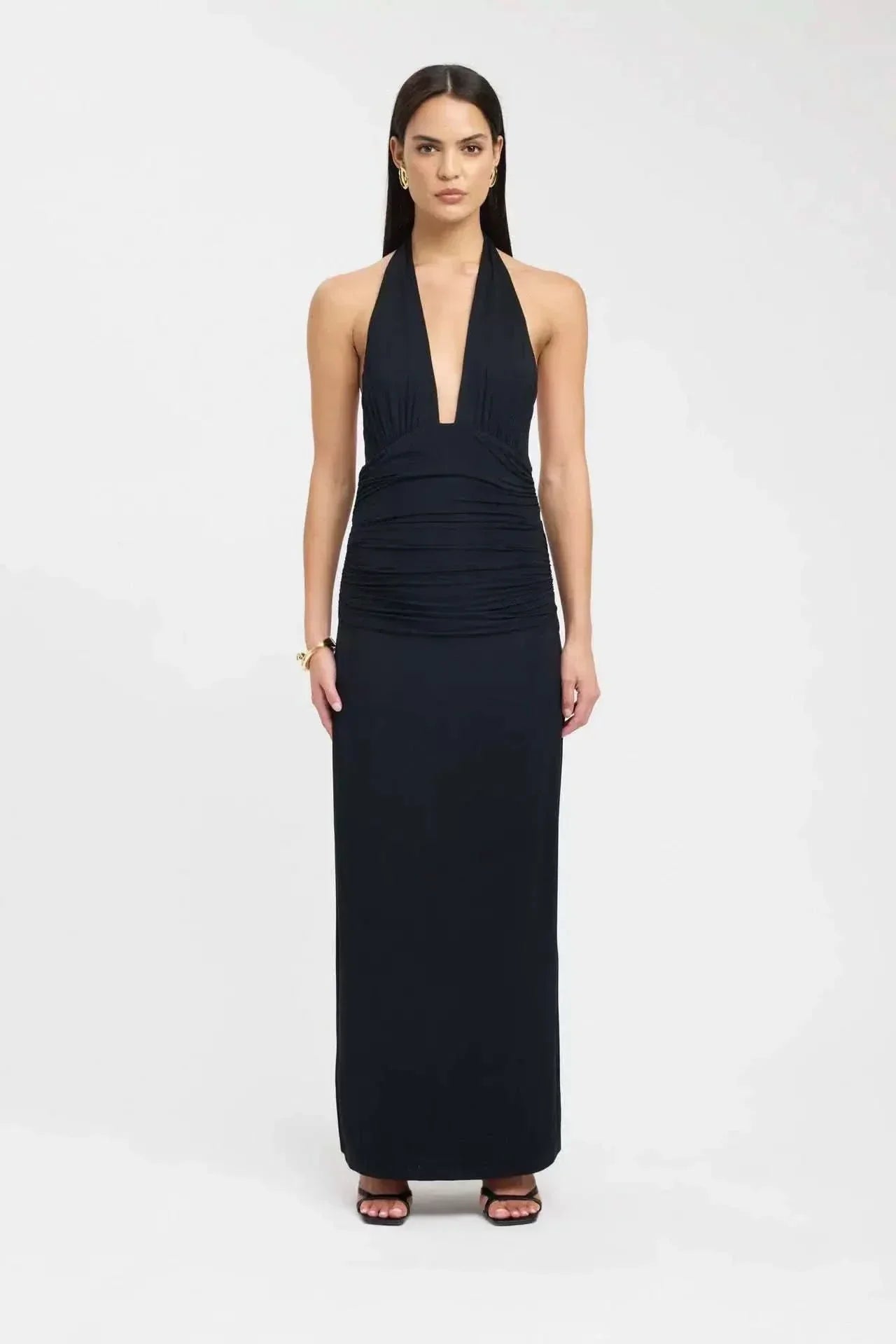 Side view of black maxi dress showing cutout ruched waist detail