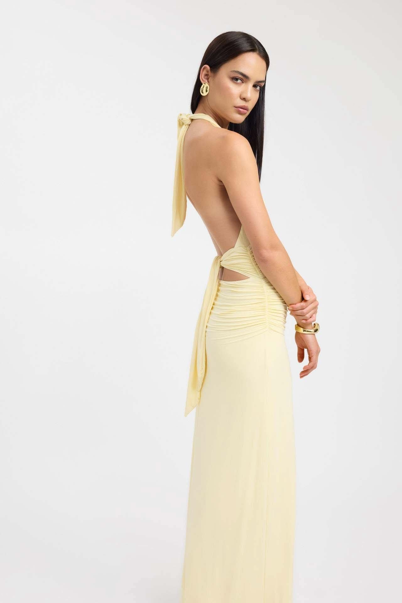 Back view of pale yellow maxi dress with halter tie and open back